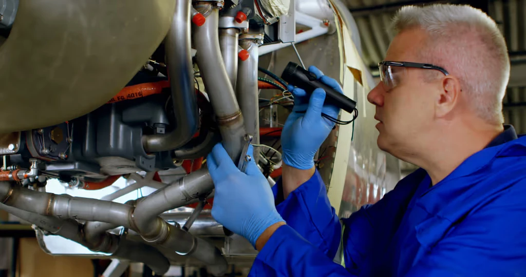 Aircraft mechanic inspecting engine